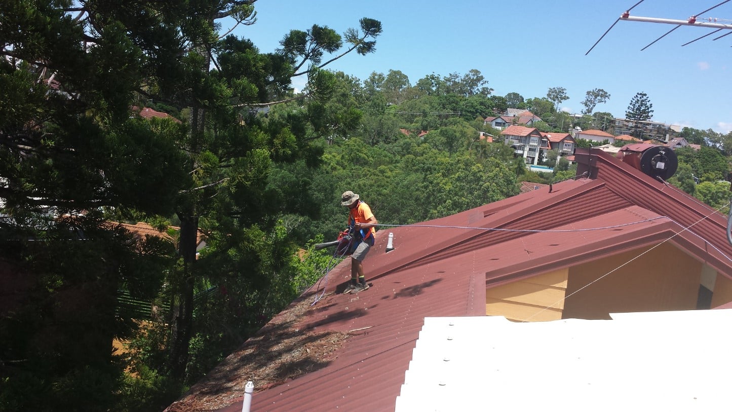 Cleaning blocked gutters and debris off a roof