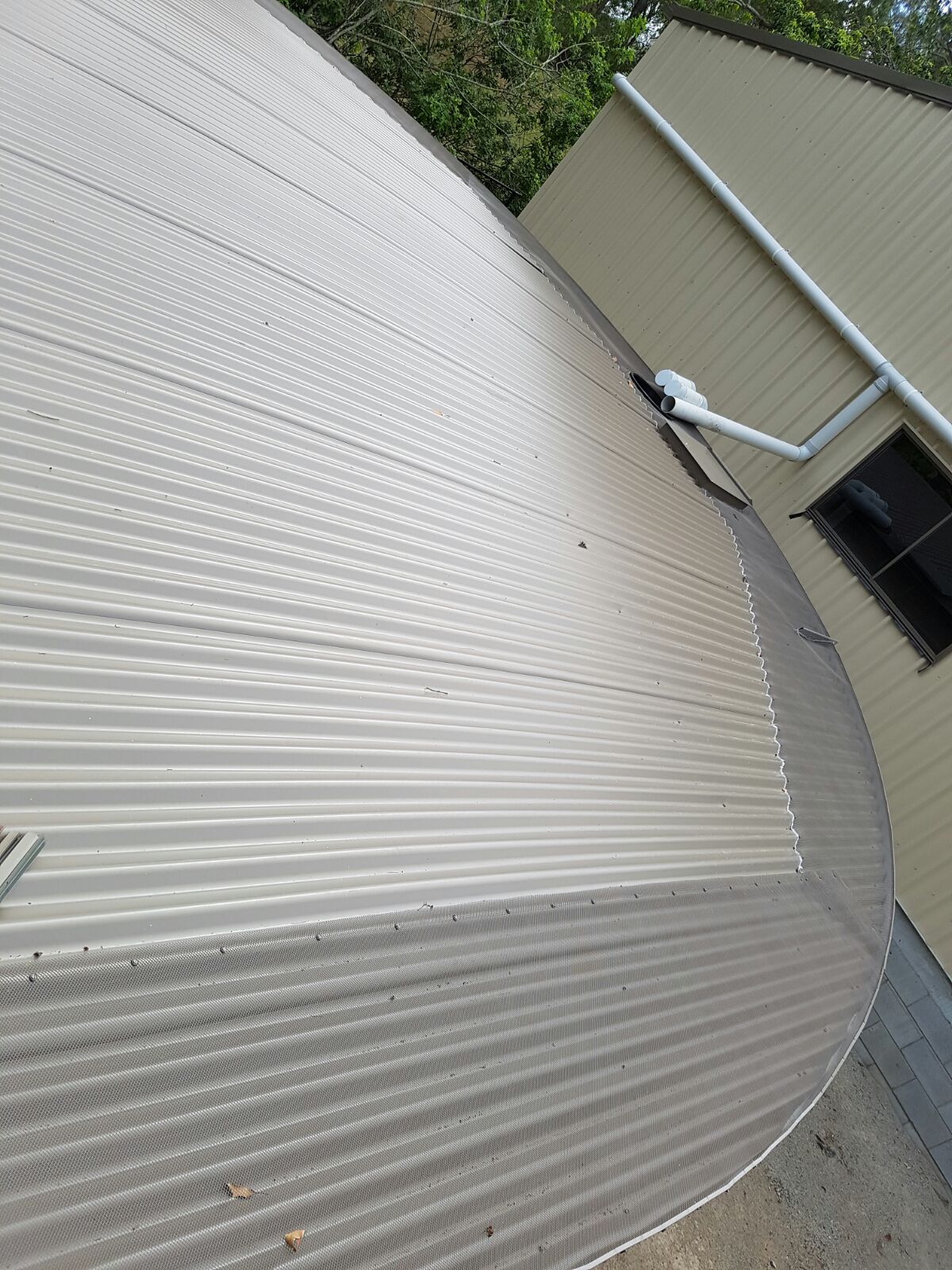 Gutter mesh installed on a commercial water tank