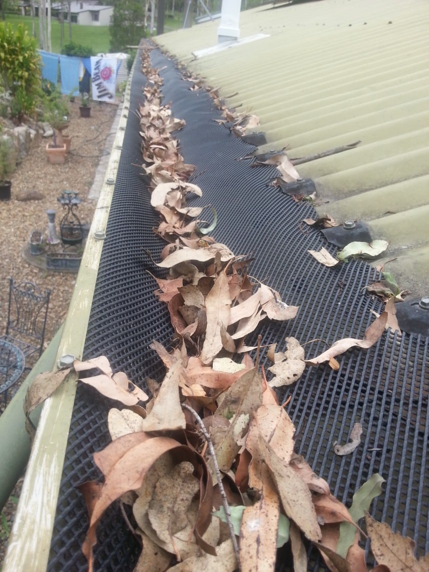 Plastic mesh has warped in the sun and lets debris and leaves build up on top creating a fire hazard