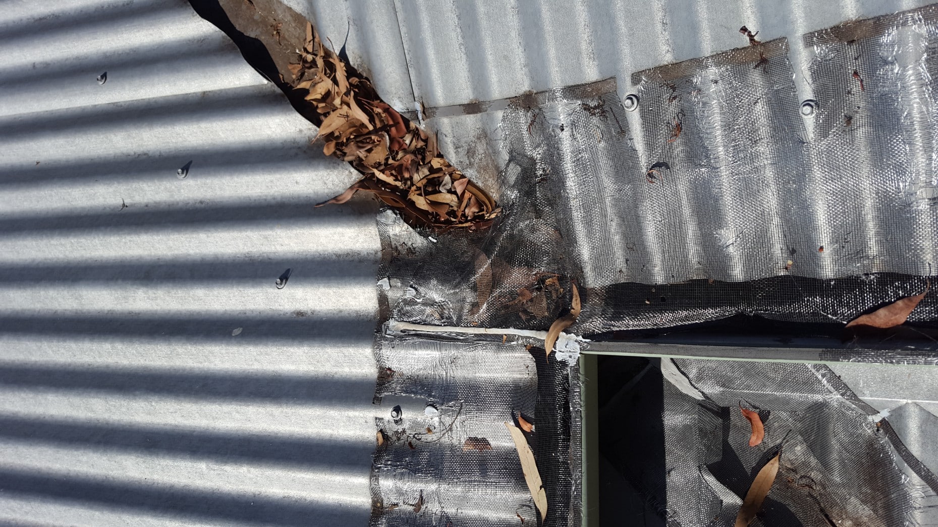 mesh using sticky on tape has failed and lets debris and leaves accumulate under blocking gutters